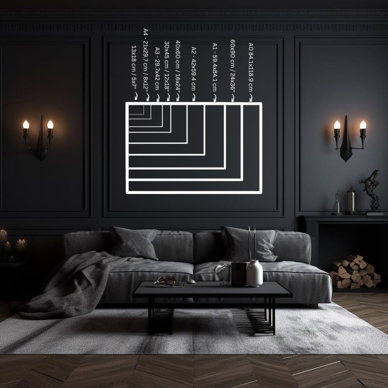 May include: A black and white illustration of different sizes of paper or poster frames on a black wall. The frames are labeled with their dimensions in centimeters and inches.