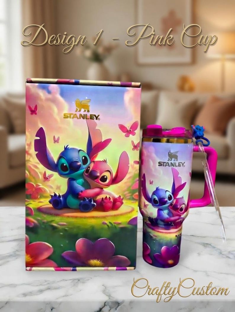 May include: A pink Stanley tumbler and matching box feature a colorful illustration of two cartoon characters. The tumbler has a pink handle and lid, and a clear straw. The box and tumbler have the text "Design 1 - Pink Cup" and "Crafty Custom".