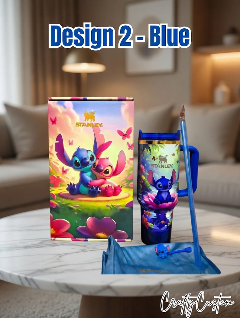 May include: A blue Stanley tumbler and accessories set featuring a cartoon character design. The set includes a tumbler, a box, a straw, and a straw topper. The box and tumbler have a colorful illustration of the character. The text "Design 2 - Blue" is at the top.