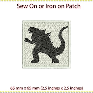 May include: A black and white iron-on or sew-on patch featuring a silhouette of a Godzilla-like monster. The patch measures 2.5 inches by 2.5 inches.