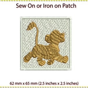 May include: Sew-on or iron-on patch featuring a cartoon lion cub with a brown and tan patterned design. The patch is 2.5 inches by 2.5 inches.