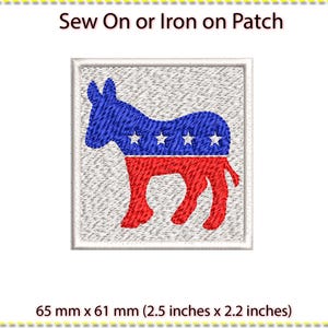 May include: Sew-on or iron-on patch featuring a blue and red donkey with white stars, representing the Democratic Party. The patch measures 6.5 cm by 6.1 cm.