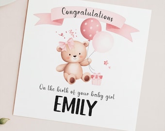 May include: A pink and white card with a teddy bear holding balloons and a gift box. The card says "Congratulations" and "On the birth of your baby girl EMILY".