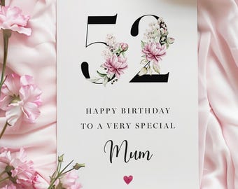 May include: A white card with black text that says "Happy Birthday to a very special Mum" with a small red heart below the text. The number 52 is in black with pink and white flowers inside the numbers.