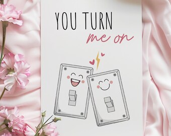 May include: A white card with the text "You turn me on" in black. Two light switch illustrations with smiley faces are below the text. The switches are facing each other and have a pink heart and lightning bolt between them.