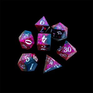 May include: A set of seven polyhedral dice, each with a dark blue and magenta glitter design. The dice feature white numbers and are used for tabletop role-playing games. The dice are set against a black background.