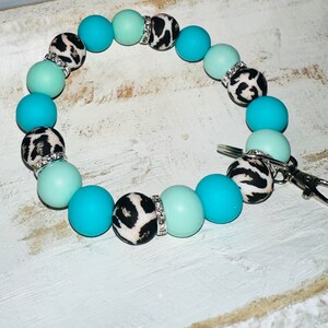 Turquoise cheetah wristlet