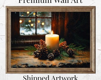 May include: A white candle with a flame sits in a pine cone wreath on a wooden surface. The candle is in front of a window with a snowy scene and twinkling lights.