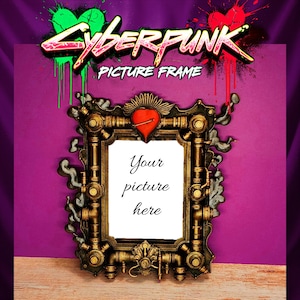 May include: A steampunk-style picture frame with a gold and bronze finish. The frame has intricate mechanical details, a red heart, and the text "Your picture here" in the center. The top of the frame has the words "Cyberpunk Picture Frame" in a graffiti style.