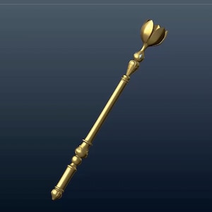 Op de afbeelding: Een gouden scepter met een decoratief bloemvormig uiteinde. De scepter heeft een lange, slanke schacht en een gedetailleerd, versierd ontwerp.