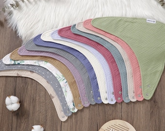 May include: A set of 15 baby bibs in various colors and patterns, including floral, geometric, and solid colors. The bibs are made of a soft, absorbent material and have a snap closure.