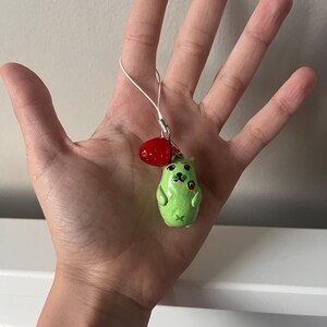 Alien puppy with a lollipop keychain