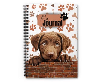 May include: Spiral-bound journal featuring a brown puppy peeking over a brick wall. The journal cover has a white background with brown paw prints, bones, and hearts. The words "My Journal" are printed on the cover.