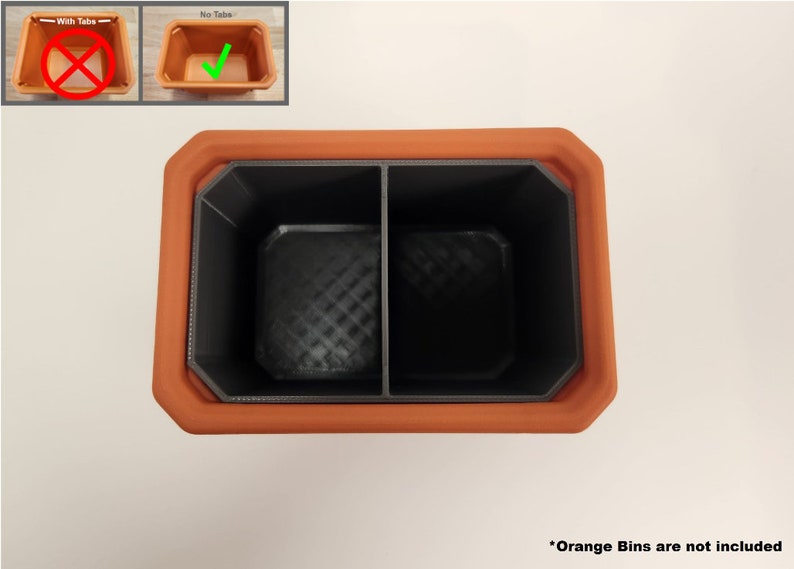 May include: A terracotta planter with a black divider inside, creating two compartments. The planter is empty and the orange bins are not included.