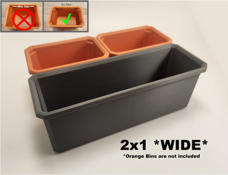 May include: A wide, grey plastic planter with two orange plastic bins inside. The planter is labelled "2x1 *WIDE*" and "Orange Bins are not included".