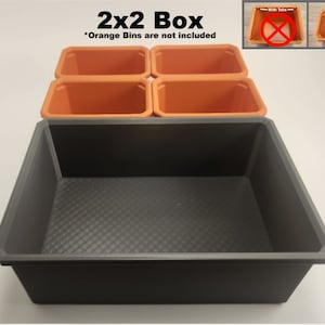 May include: A black plastic storage box with four orange plastic bins inside. The box is labelled "2x2 Box" and "Orange Bins are not included".