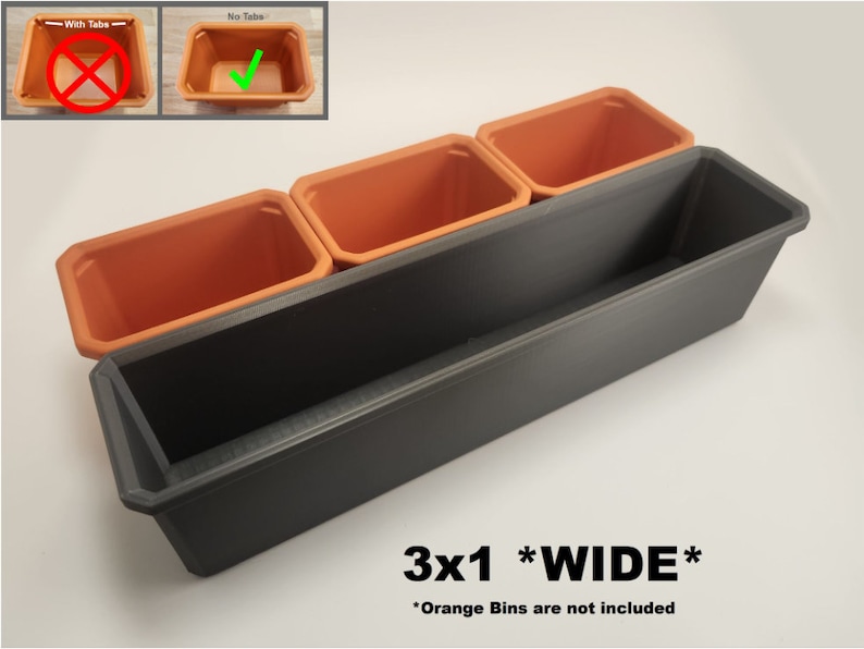 May include: A black plastic planter with three orange plastic pots inside. The planter is labelled "3x1 *WIDE*" and "Orange Bins are not included".