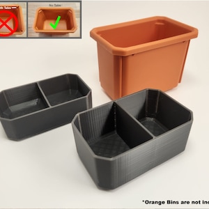 May include: Two black plastic divided storage containers with a single orange plastic container in the background. The text "Orange Bins are not included" is at the bottom of the image.