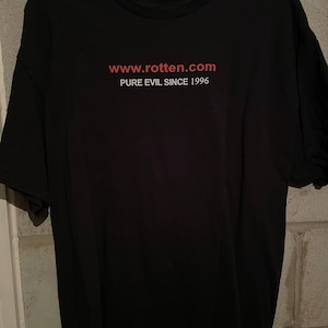 May include: Black t-shirt with the text "www.rotten.com PURE EVIL SINCE 1996" in red.