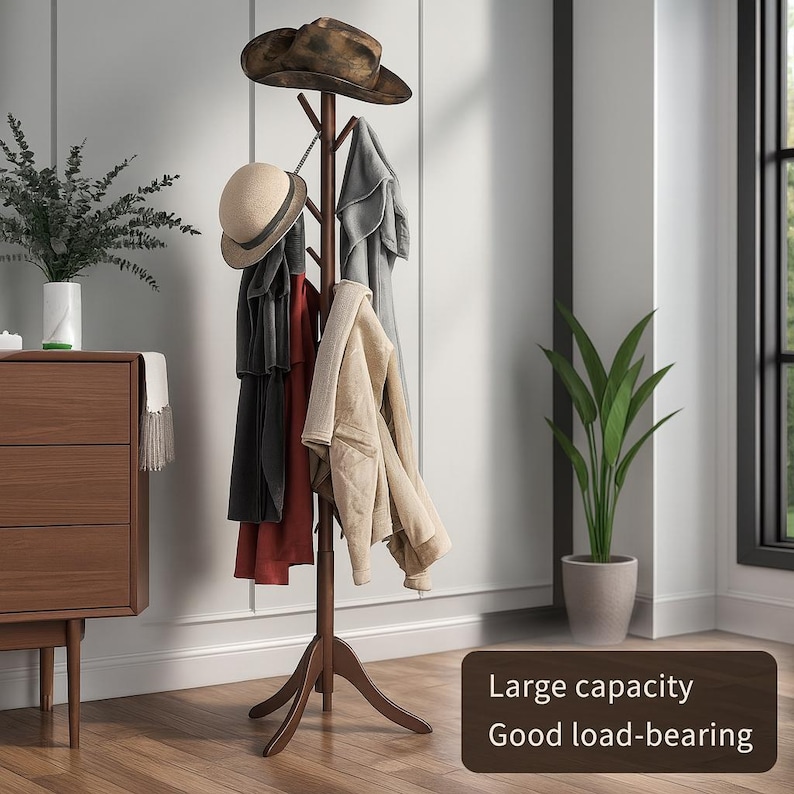 May include: A dark brown wooden coat rack with multiple branches for hanging items. Several coats and hats are displayed on the rack. The text on the image says "Large capacity Good load-bearing."
