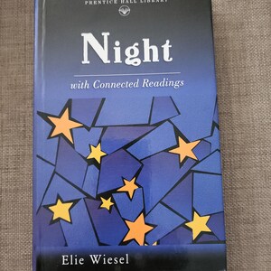 May include: A hardcover book titled "Night with Connected Readings" by Elie Wiesel. The cover features a dark blue background with a mosaic pattern and yellow stars. The title is in large white letters.
