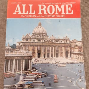 May include: A vintage travel book titled "ALL ROME" with a photograph of St. Peter's Basilica and the Vatican. The cover is red and white with the title in large, bold letters. The image includes buses and cars in the foreground.