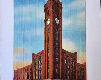 May include: Vintage postcard featuring Grand Central Station in Chicago, with the text "196- Grand Central Station, Chicago Wells and Harrison Sts." The building is a tall, brick structure with a clock tower, set against a blue sky.