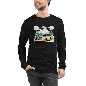 May include: Black long-sleeve t-shirt with a white and yellow Audi rally car driving through a snowy mountain landscape with pine trees.