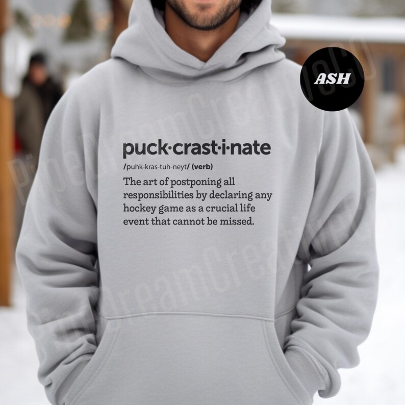 May include: Gray hoodie with a definition of the word "puck-crast-i-nate" printed on the front. The definition is "The art of postponing all responsibilities by declaring any hockey game as a crucial life event that cannot be missed."