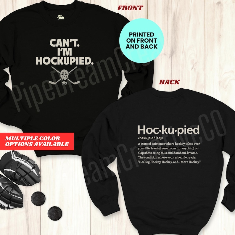 May include: Black sweatshirt with the text "CAN'T. I'M HOCKUPIED." on the front and a definition of "Hoc-ku-pied" on the back. The sweatshirt is available in multiple colors.