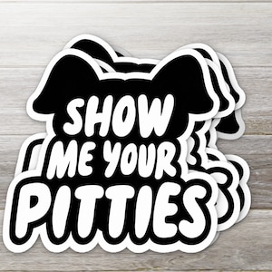 May include: Black and white sticker with a dog silhouette and the text "Show me your pitties".