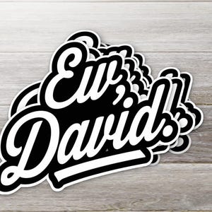 May include: A stack of black and white stickers with the text "Hi, David!" in a bold, cursive font.