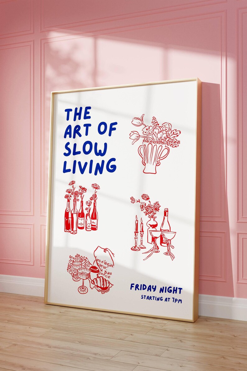 May include: A framed art print with a white background and red and blue illustrations. The text "THE ART OF SLOW LIVING" is in blue. Red illustrations include flowers, bottles, and glassware. The phrase "FRIDAY NIGHT STARTING AT 7PM" is also in blue.