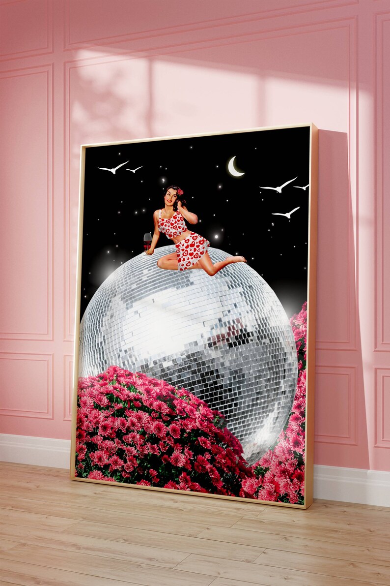 May include: A woman in a red and white polka dot dress sits on a large silver disco ball. The disco ball is surrounded by pink flowers. The background is a dark blue night sky with stars and a crescent moon.