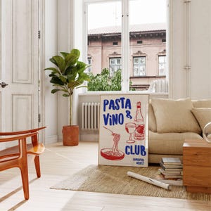 May include: A white poster with red and blue text that reads "PASTA VINO & CLUB CONCOCTED WEEKLY". The poster features a hand-drawn illustration of a bowl of pasta, a glass of wine, and a bottle of wine.