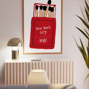 May include: A red matchbox with the text "New York City Classic NYC" and a drawing of matches inside.