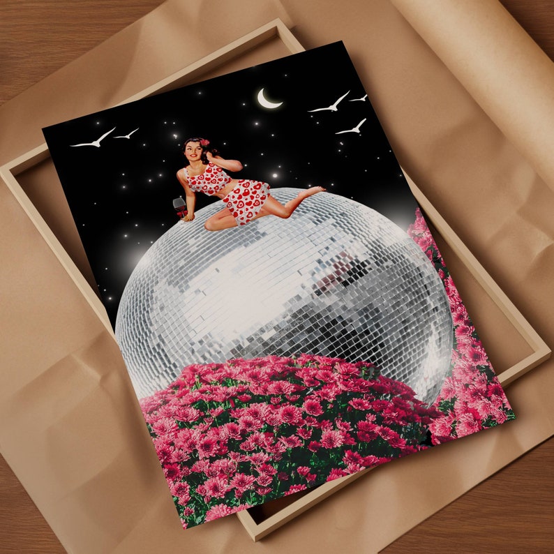 May include: A woman in a red and white polka dot dress sits on a large disco ball surrounded by pink flowers. The disco ball is reflecting light and the woman is holding a glass of red liquid.