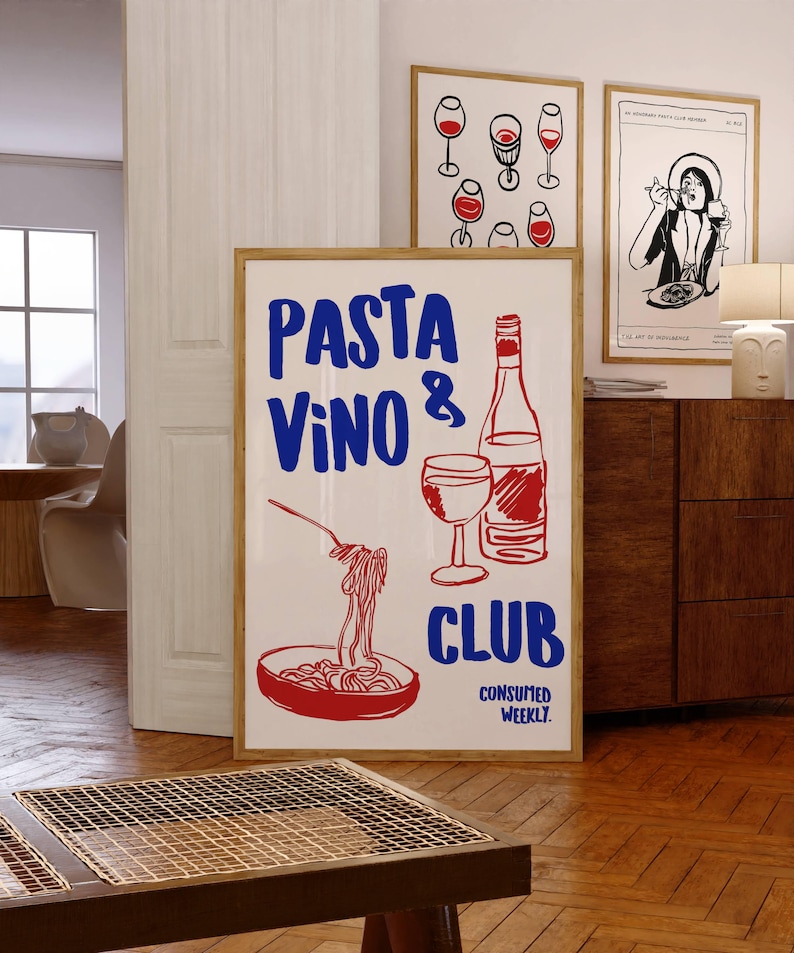 May include: A white poster with red and blue text that reads "PASTA VINO & CLUB CONSUMED WEEKLY." The poster features a hand-drawn illustration of a bowl of pasta, a glass of wine, and a bottle of wine.