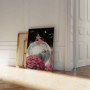 May include: A woman in a pink and white polka dot dress sits on a large disco ball surrounded by pink flowers. The background is a dark blue night sky with a crescent moon and white birds.