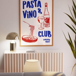 May include: A white poster with red and blue text that reads "PASTA VINO & CLUB CONSUMED WEEKLY". The poster features a hand-drawn illustration of a bowl of pasta, a glass of wine, and a bottle of wine.