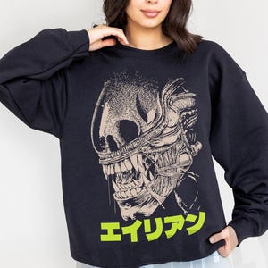 Retro original Alien movie sweatshirt, unisex sci-fi horror movie crewneck sweatshirt with Japanese movie poster text and streetwear style design on an oversized black sweater