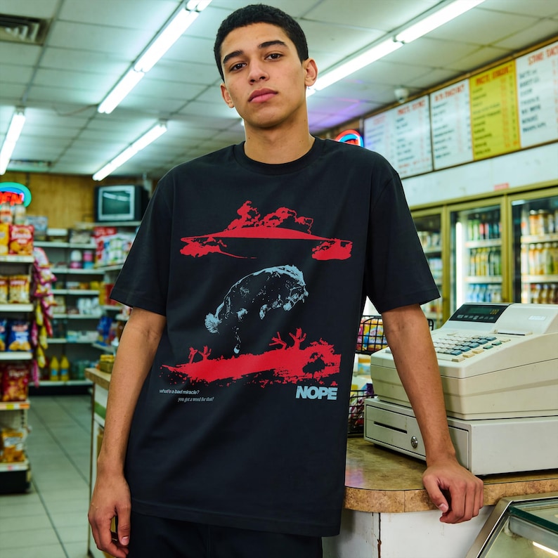 Jordan Peele Nope movie graphic tee, retro sci-fi horror movie t-shirt with UFO Aliens for Nope form Get Out director, unisex black horror movie shirt