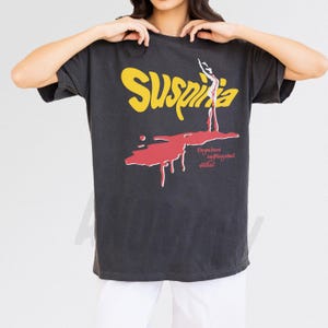 Vintage Suspiria 1977 horror movie t-shirt, retro 70s Italian horror movie suspiria movie poster graphic on distressed black comfort colors tee shirt