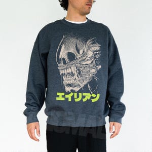 Retro original Alien movie sweatshirt, unisex sci-fi horror movie crewneck sweatshirt with Japanese movie poster text and streetwear style design on an oversized dark heather gray sweater