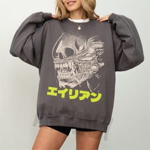 Retro original Alien movie sweatshirt, unisex sci-fi horror movie crewneck sweatshirt with Japanese movie poster text and streetwear style design on an oversized dark grey sweater