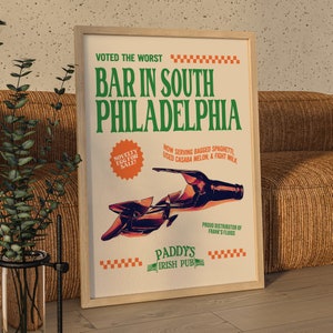 May include: A vintage-style poster advertising Paddy's Irish Pub in South Philadelphia. The poster features a broken bottle and the text "Voted the worst bar in South Philadelphia."  It also says "Now serving bagged spaghetti, used casaba melon, & fight milk." and "Proud distributor of Frank's Fluids."