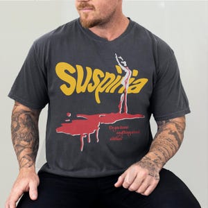 Vintage Suspiria 1977 horror movie t-shirt, retro 70s Italian horror movie suspiria movie poster graphic on oversized washed black comfort colors tee shirt