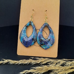 Paire de boucles d'oreilles faite pour sublimer vos tenues,grâce à son mélange unique de bleu Crochets : doré