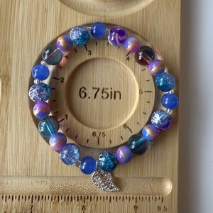 Purple and blue beaded bracelet with silver leaf charm