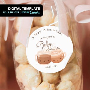 May include: Clear cellophane bags filled with white treats, tied with pink ribbons. A round sticker reads "A Baby is Brewing!" with "Ashley's Baby Shower" and the date 08.23.2027. The top left corner has a black banner that says "DIGITAL TEMPLATE".
